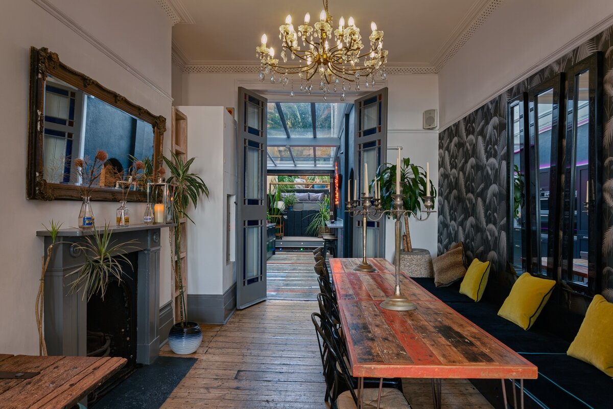 Zanzibar House dining room with long table and crystal chandelier