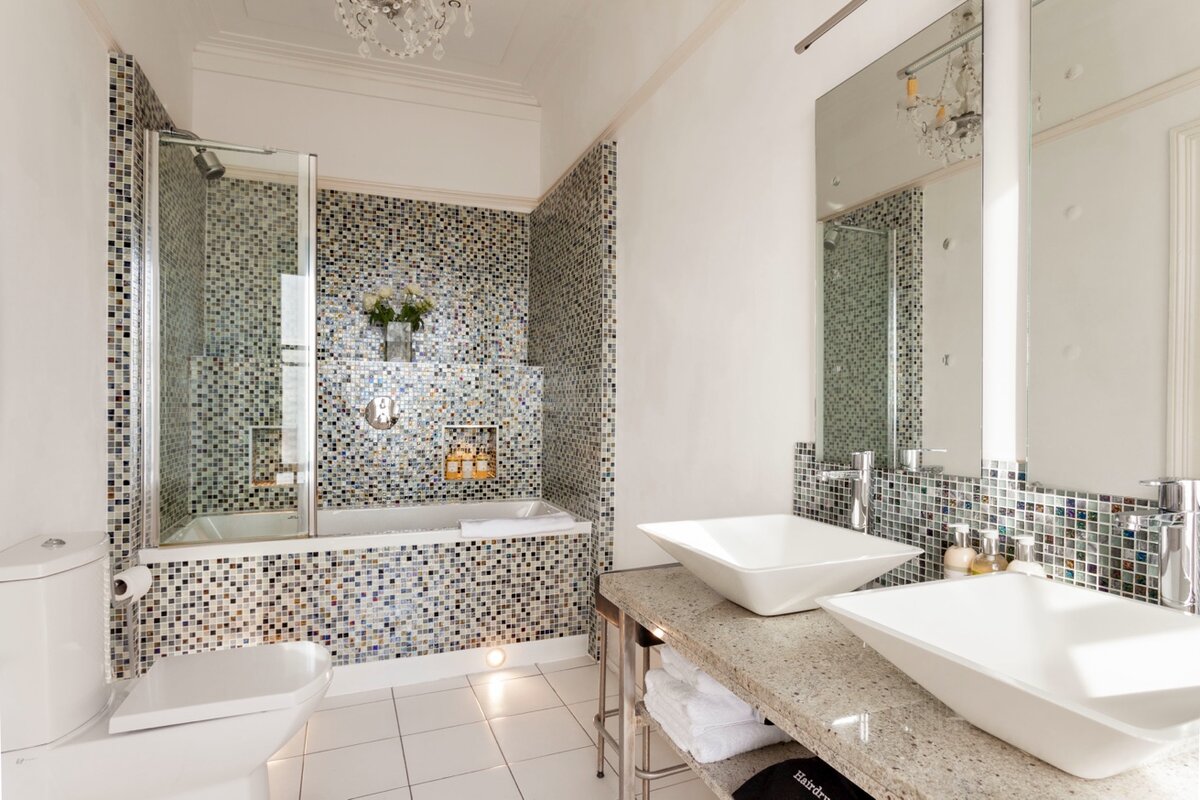 Antarctica Room — mosaic tile ensuite with bath and chandelier
