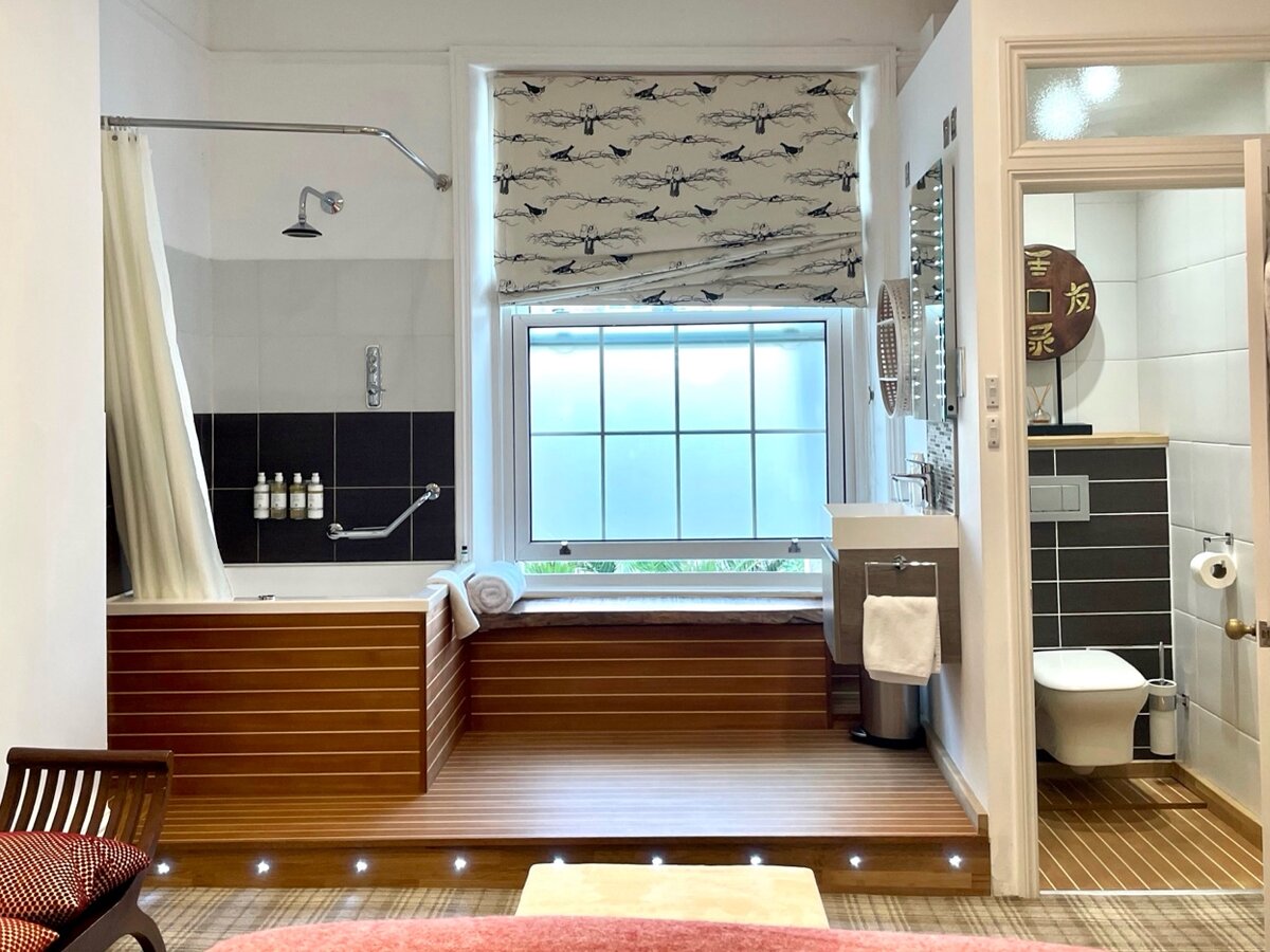 Japan Room — teak-decked bathroom platform with bath and bird-print blind