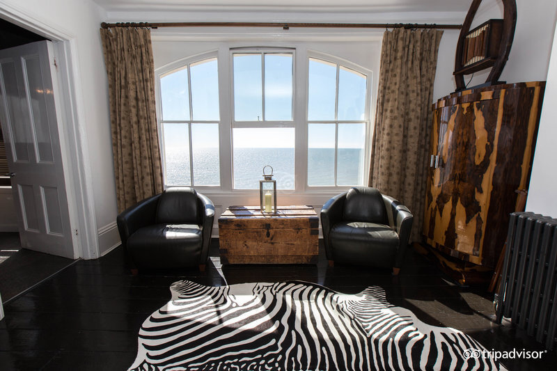Africa Room — leather chairs, zebra rug and arched sea view