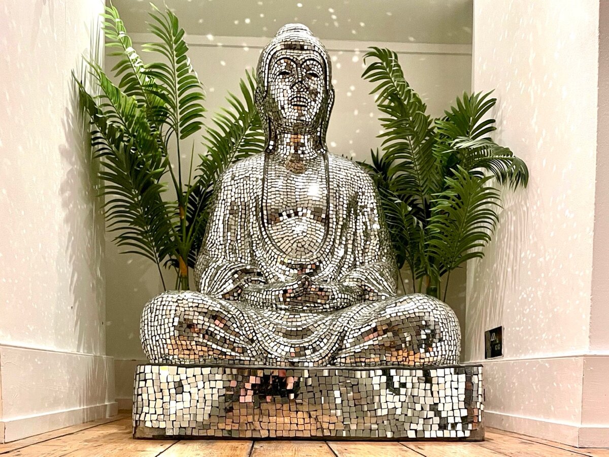 Mirror mosaic Buddha sculpture in Zanzibar House hallway