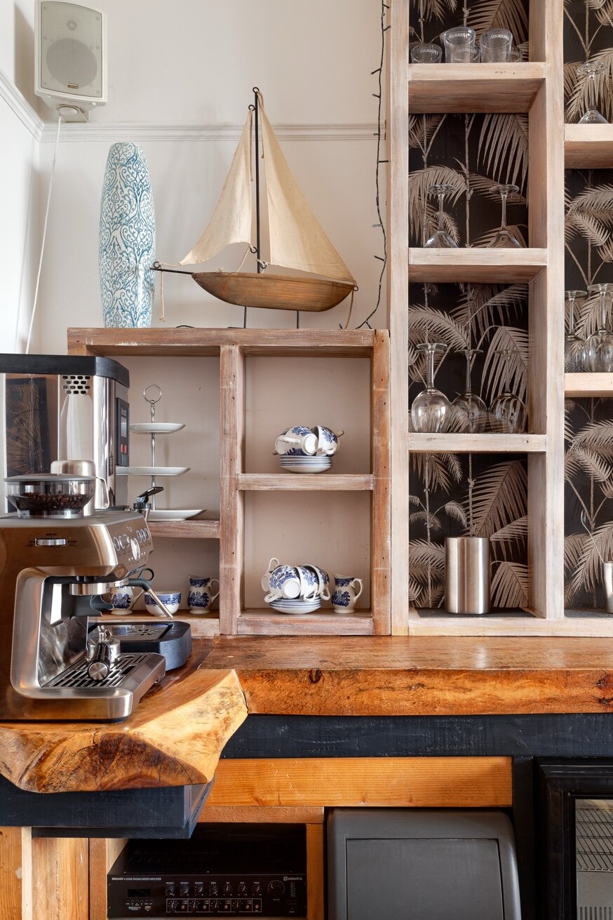 Hand-carved wood panel and navy bench in Zanzibar House lounge